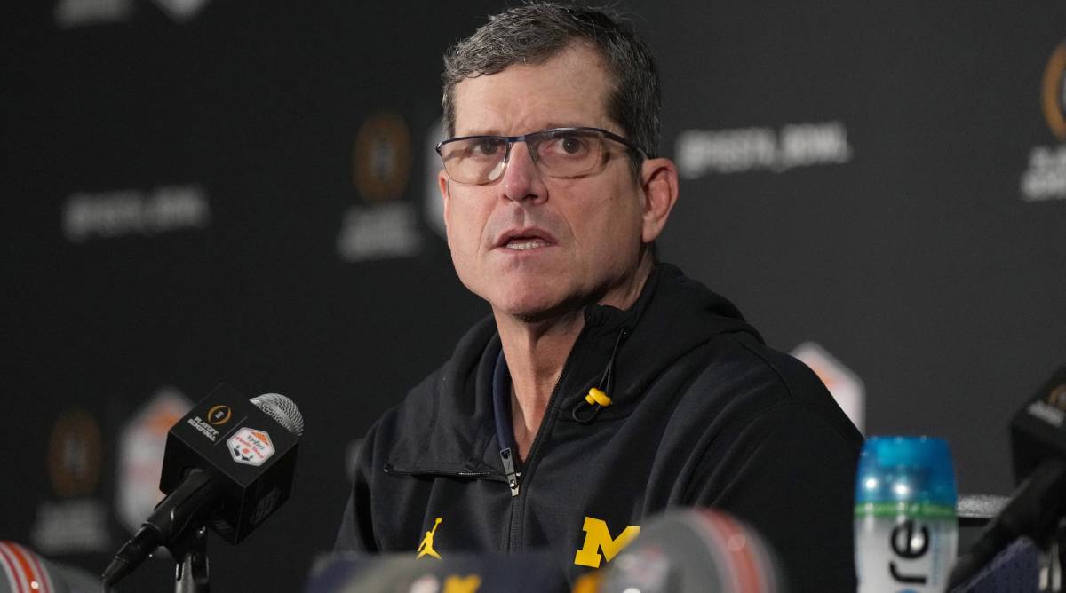 Michigan head coach Jim Harbaugh speaks with media after the Fiesta Bowl vs. TCU.
